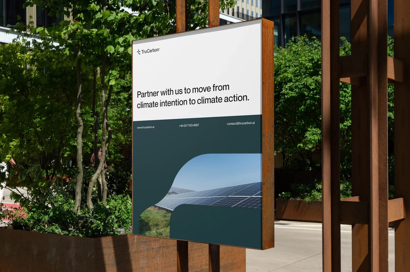 TruCarbon sustainability campaign poster beside plants